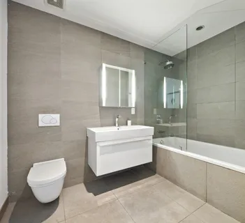 a bathroom with a sink a toilet and bathtub