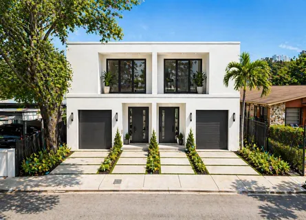 a house with palm tree in front of it