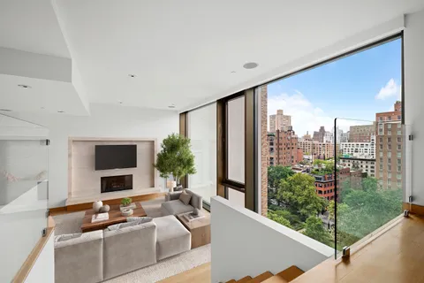 a living room with furniture tv and a large window