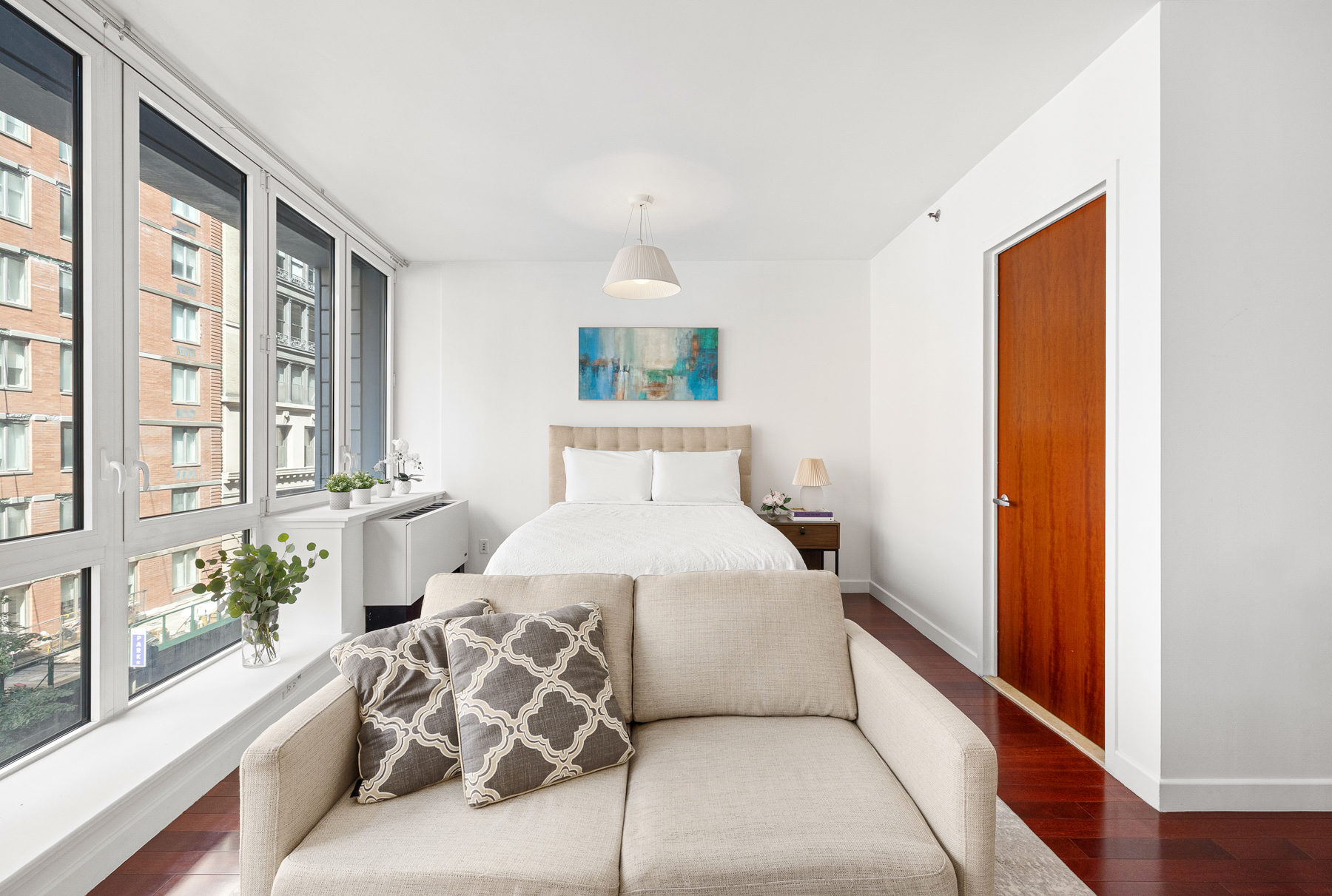 125 West 21st Street, Unit 4C Manhattan, NY 10011 - Photo 4 of 12 a bedroom with a large bed and a window