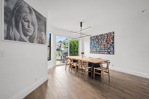 an aerial view of residential houses with outdoor space and lake view