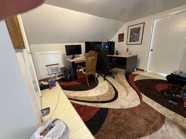 a view of a house with wooden fence and trees