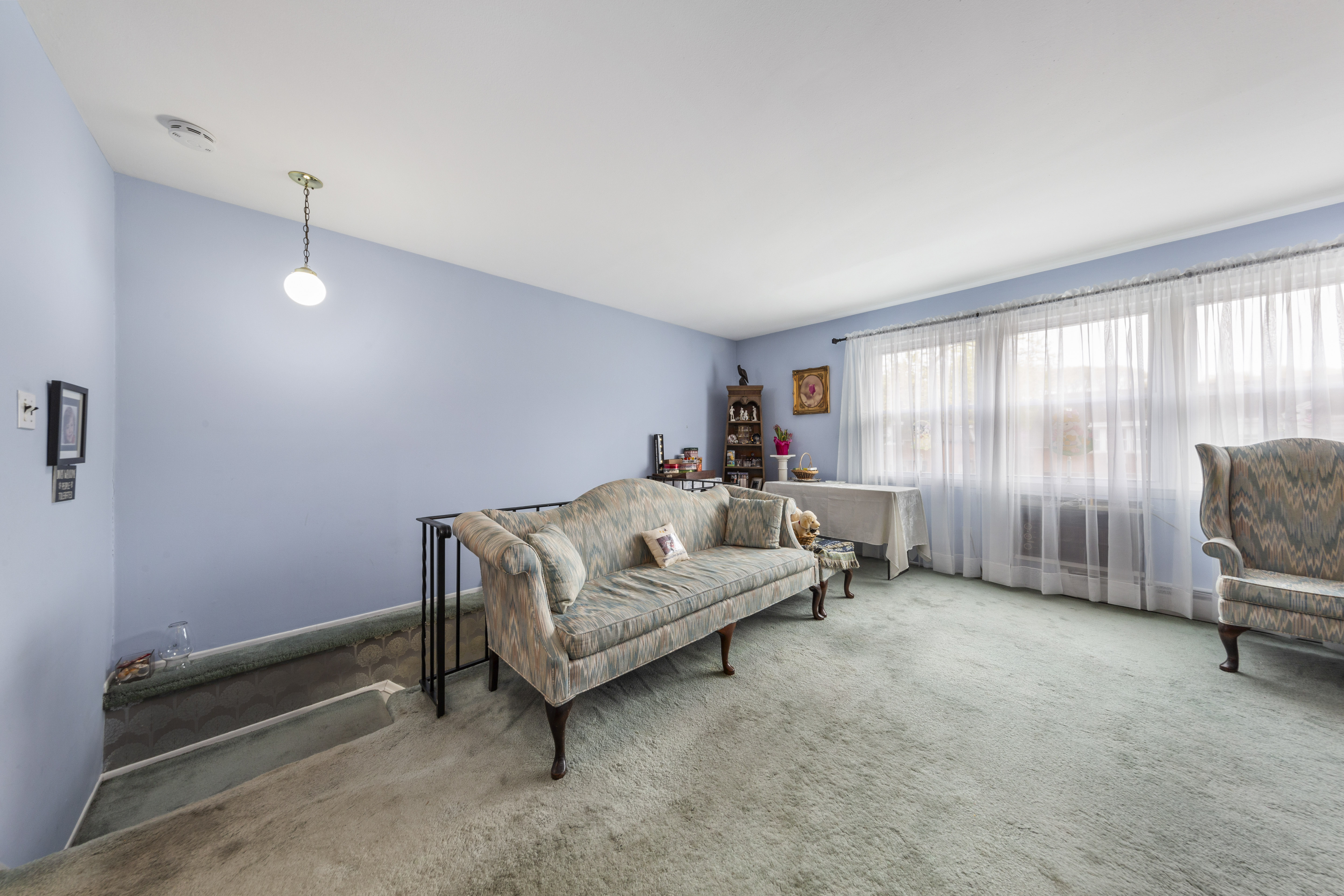 240-47 68th Avenue Queens, NY 11362 - Photo 13 of 39 a living room with furniture and a window