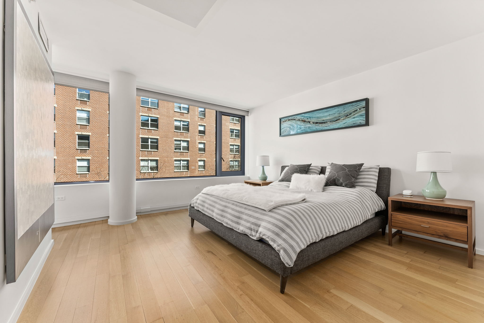 425 West 53rd Street, Unit 416 Manhattan, NY 10019 - Photo 6 of 19 a bedroom with a large bed and a window