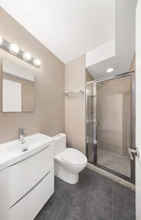 a bathroom with a toilet a sink and shower