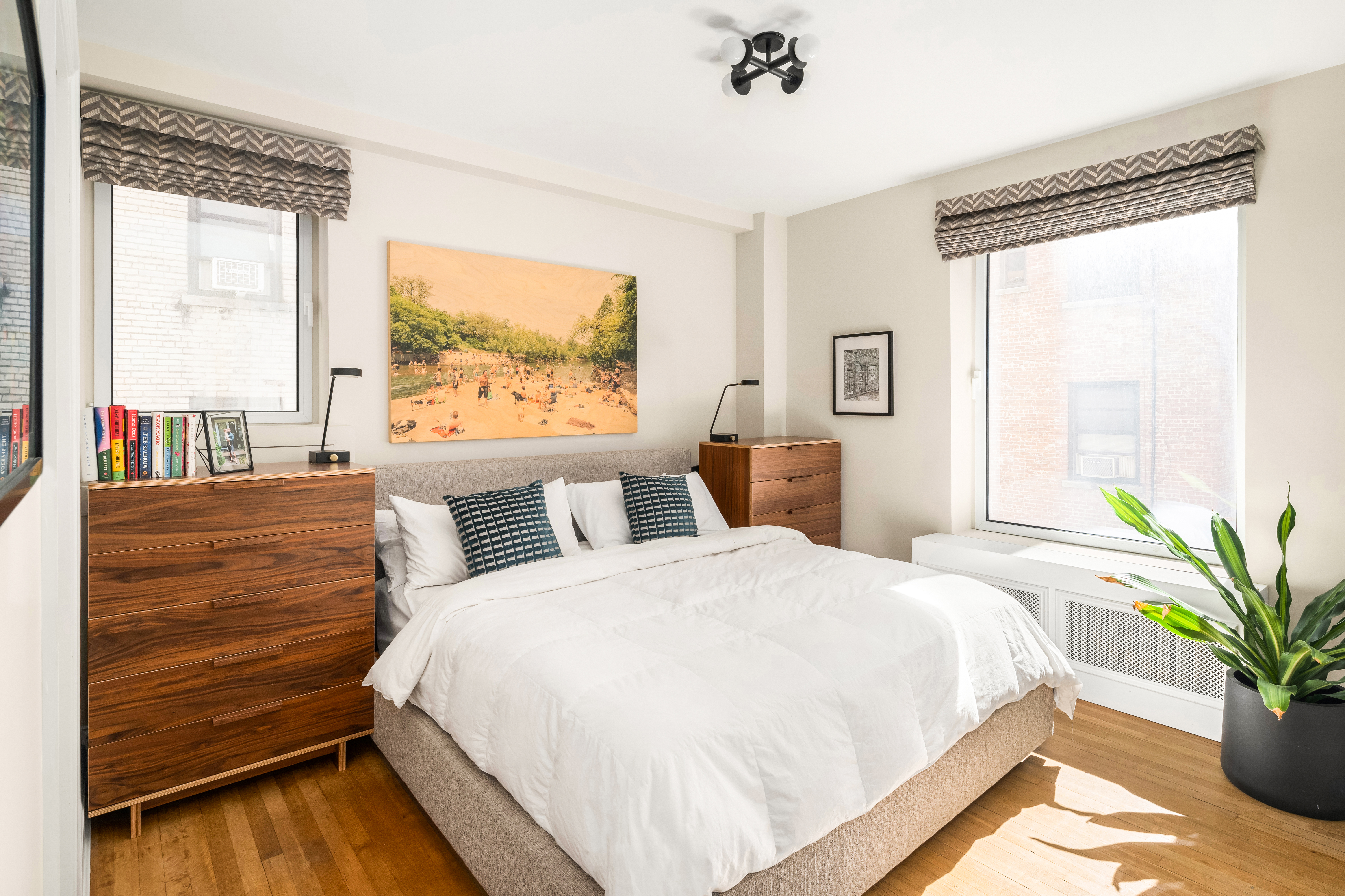 138 East 36th Street, Unit 4C Manhattan, NY 10016 - Photo 8 of 17 a bed sitting in a bedroom next to a window