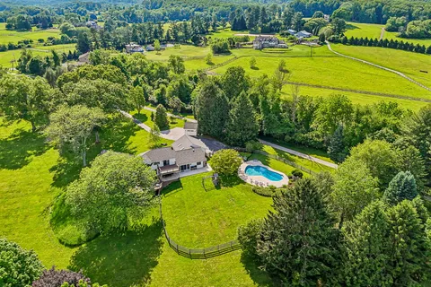 a huge green field with lots of trees