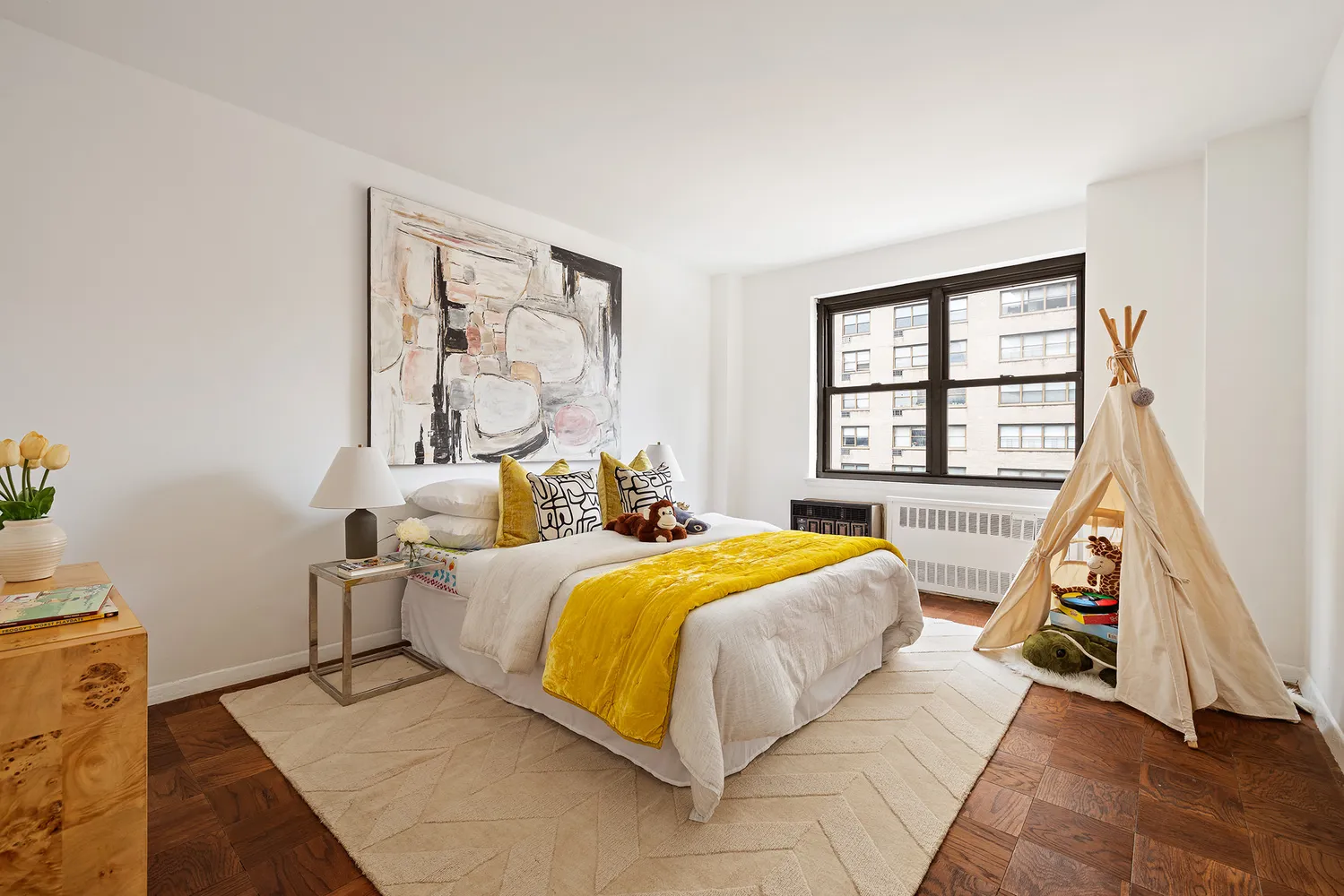 a bedroom with a bed and wooden floor
