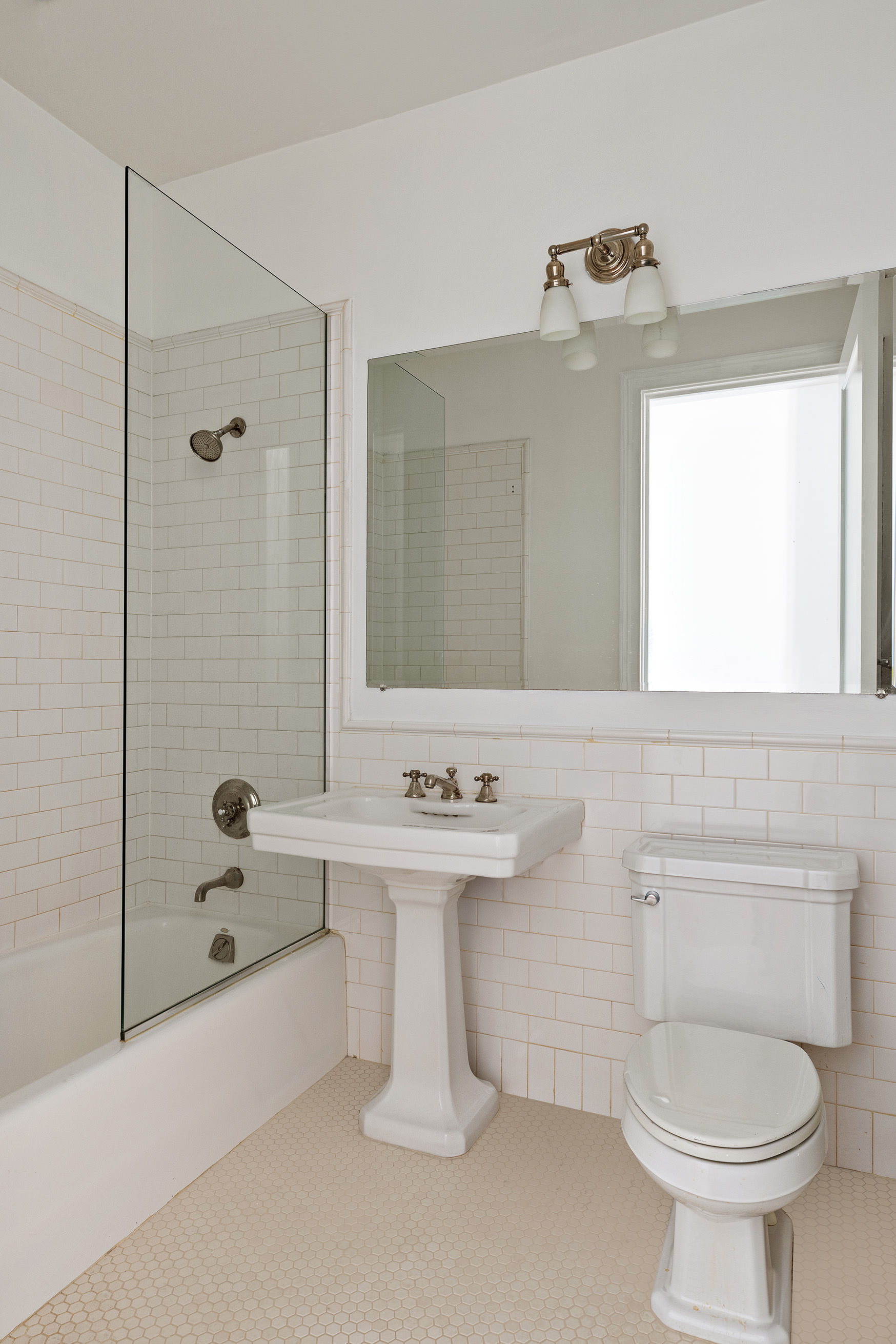 285 Lafayette Street, Unit 2B Manhattan, NY 10012 - Photo 13 of 19 a bathroom with a sink toilet and shower