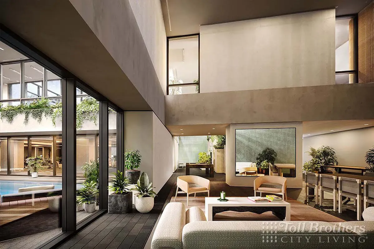 a living room with furniture large windows and wooden floor