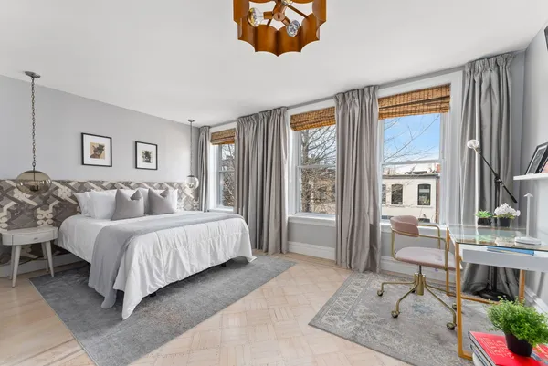 a spacious bedroom with a bed and a large window