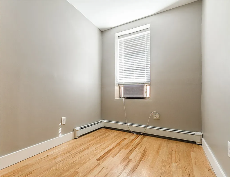 406 Monroe Street, Unit 3 Brooklyn, NY 11221 - Photo 7 of 11 a view of a room with wooden floor and a window