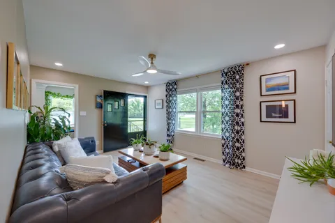 a living room with furniture and a wooden floor