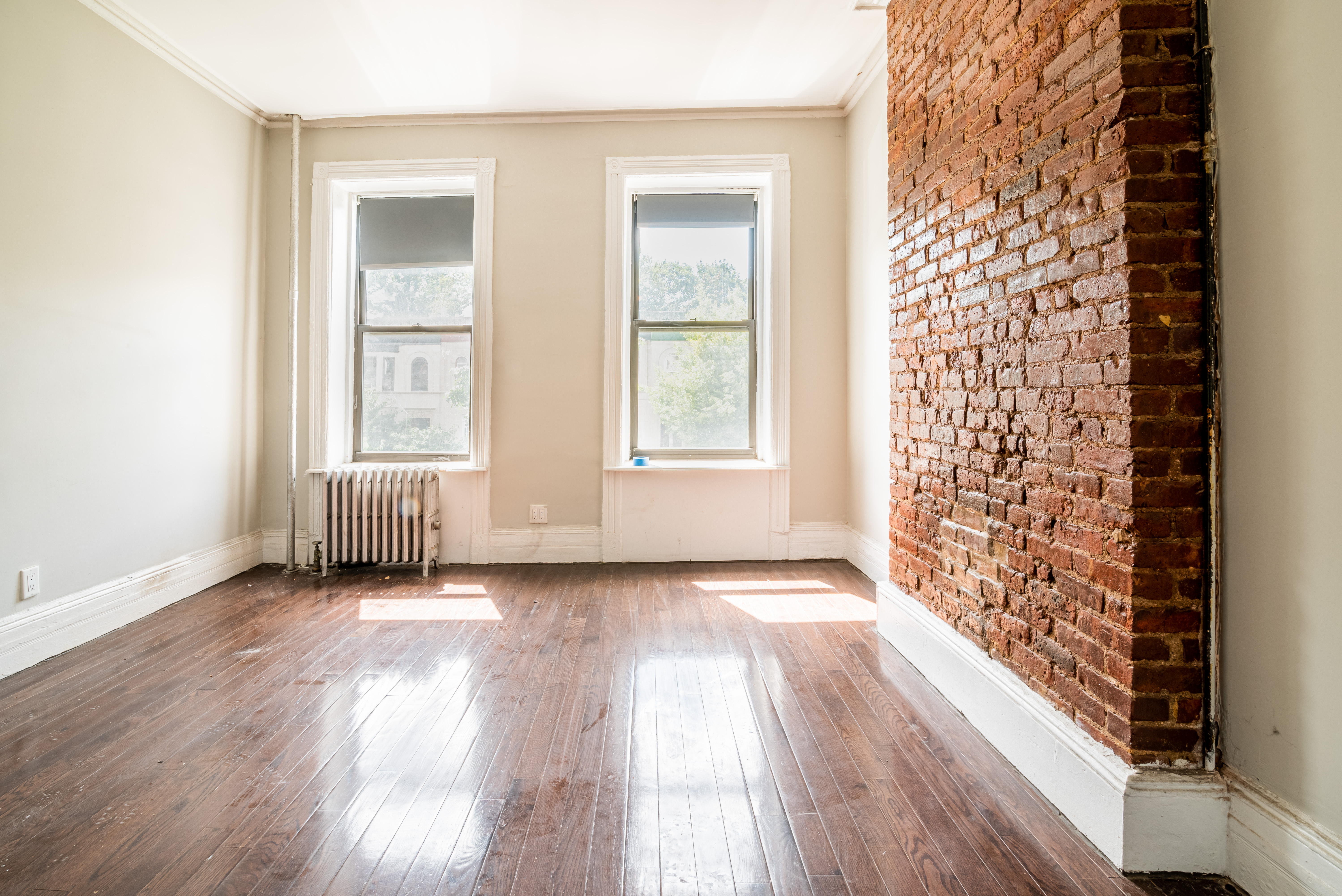 681 Sterling Place, Unit 2L Brooklyn, NY 11216 - Photo 3 of 8 an empty room with wooden floor and windows