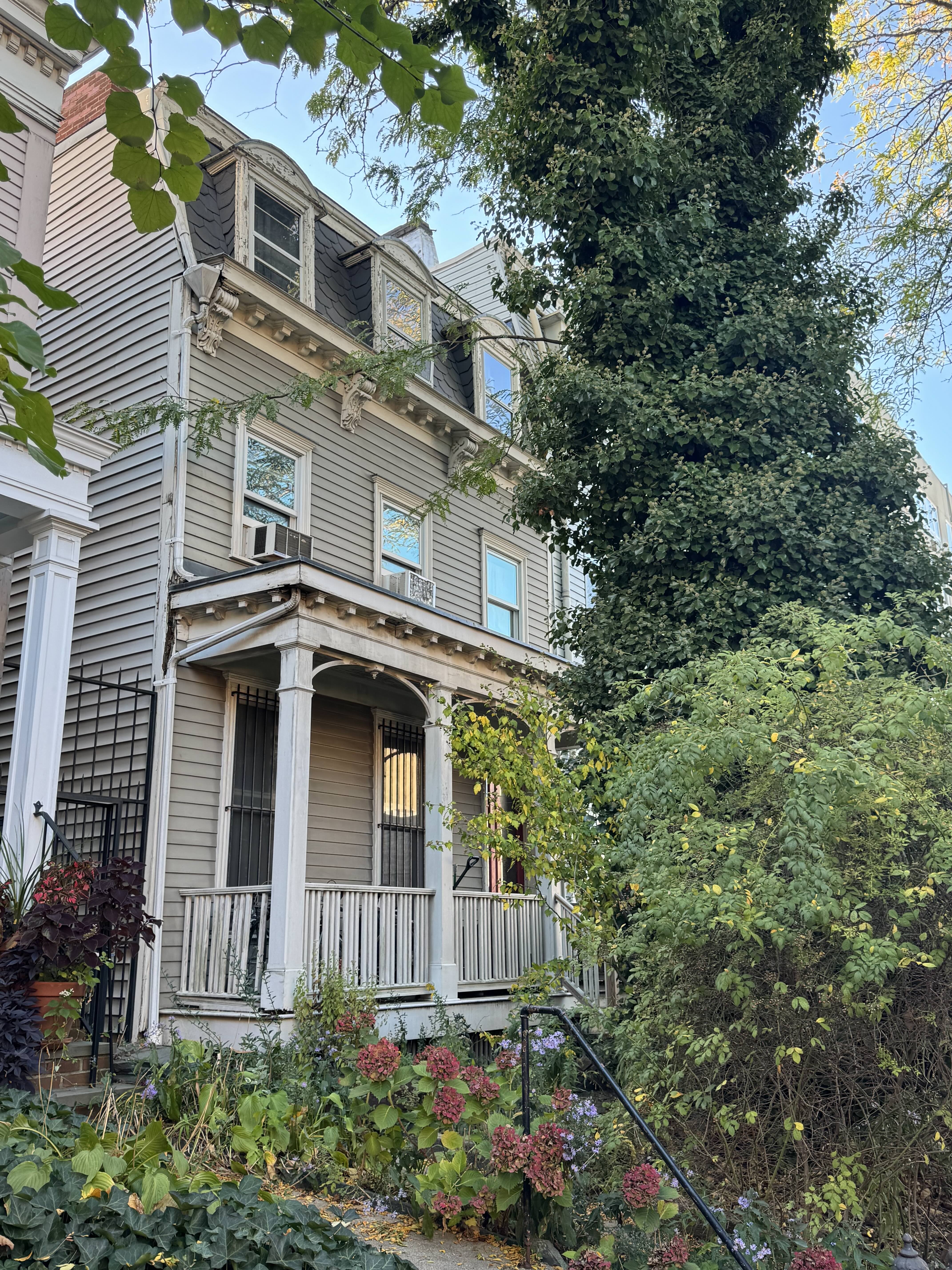 a front view of a house with a garden