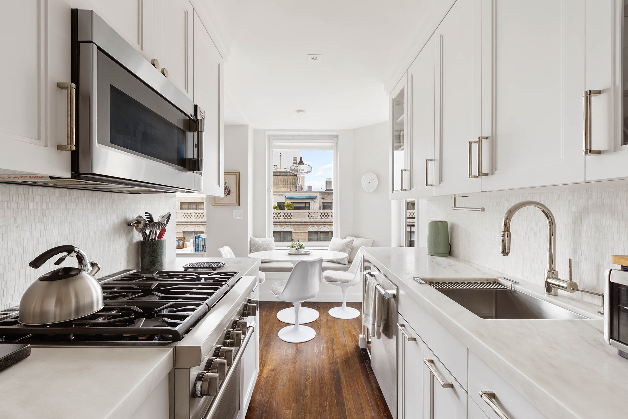 49 East 86th Street, Unit 17B Manhattan, NY 10028 - Photo 4 of 11 a kitchen that has a sink and a stove