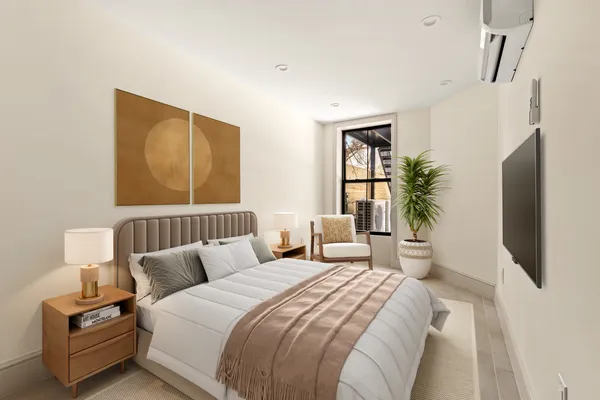 a bedroom with a large bed and a window