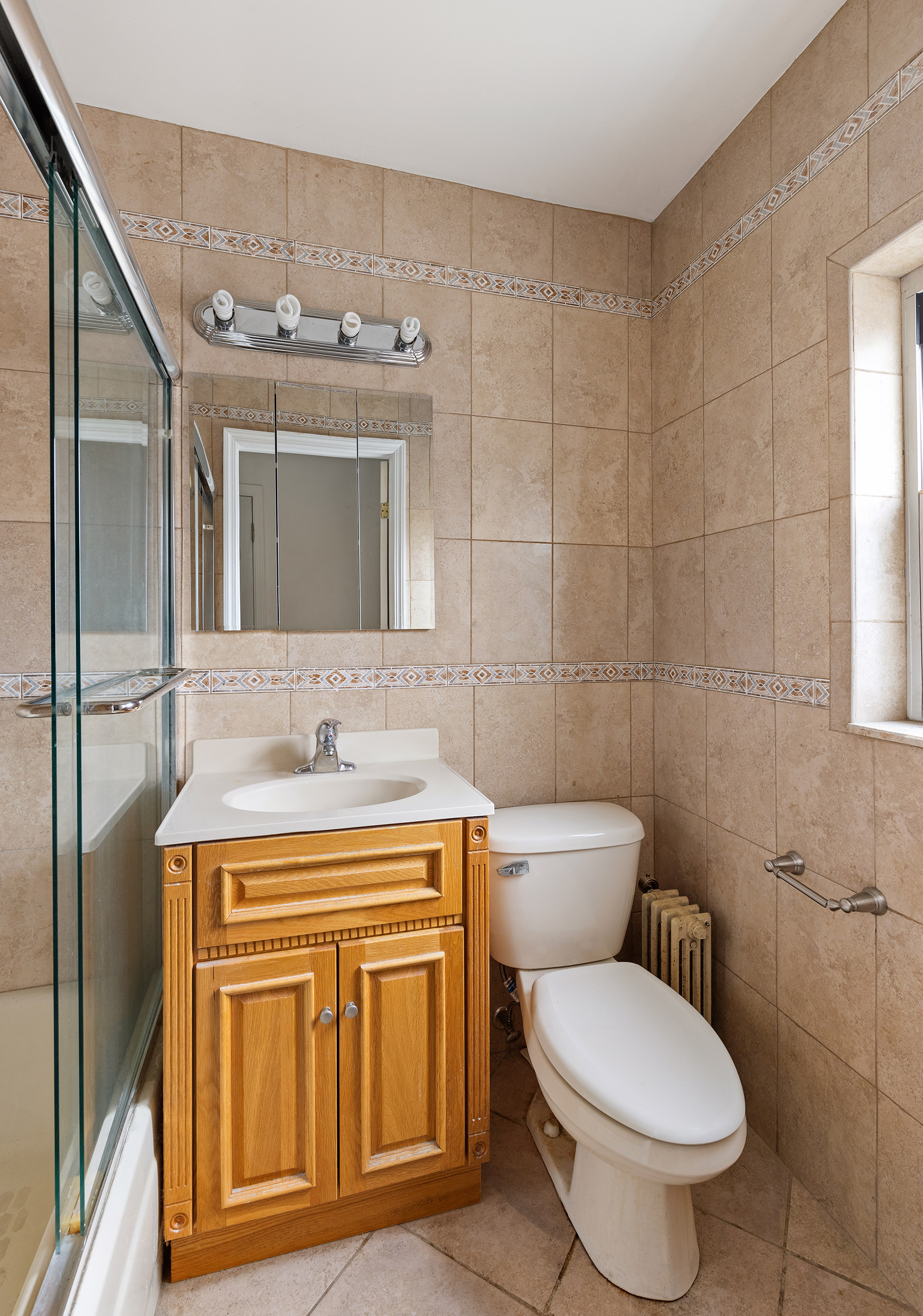 31-22 36th Street Queens, NY 11106 - Photo 8 of 10 a bathroom with a toilet a sink and mirror