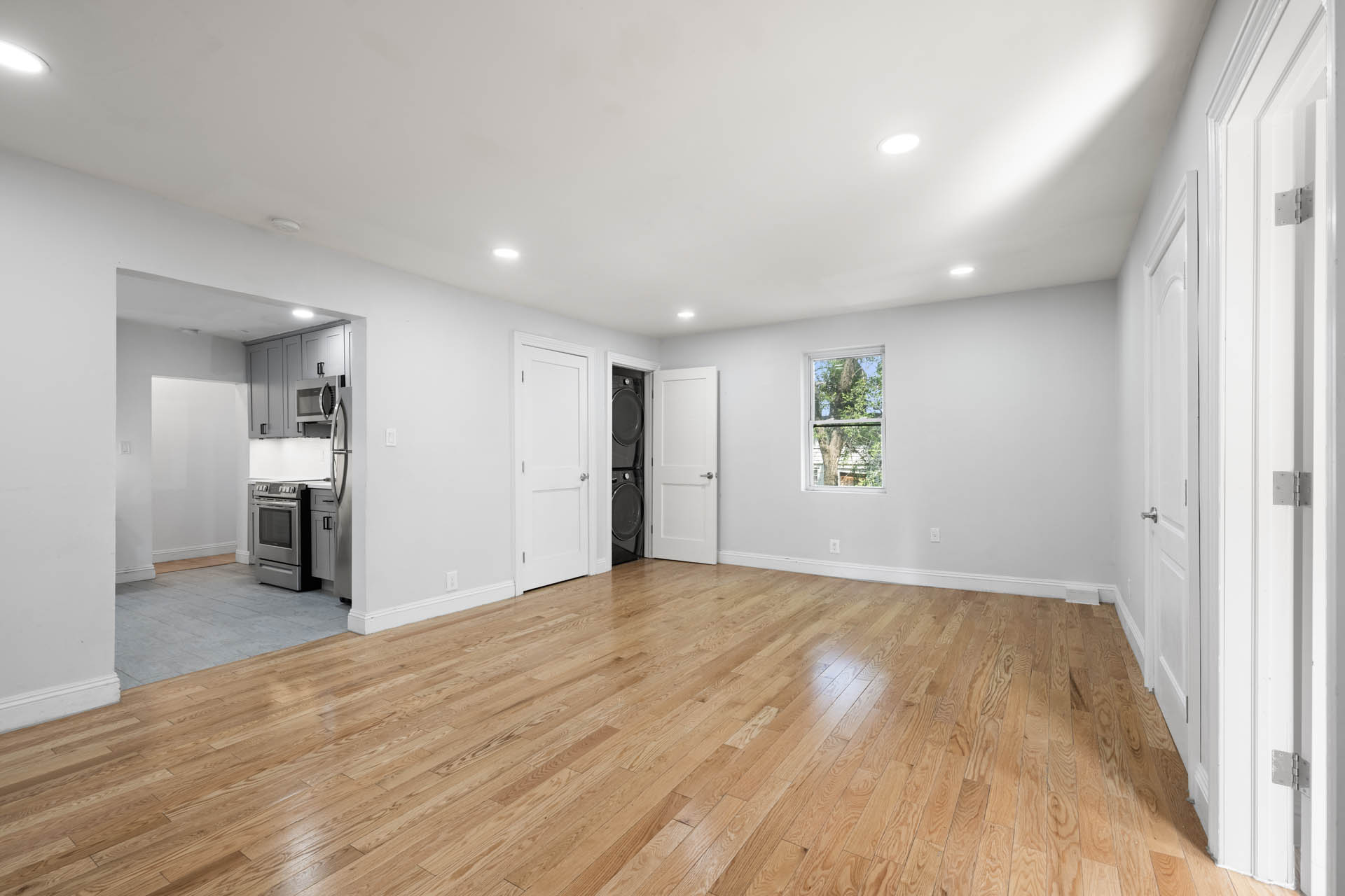 a view of empty room with wooden floor