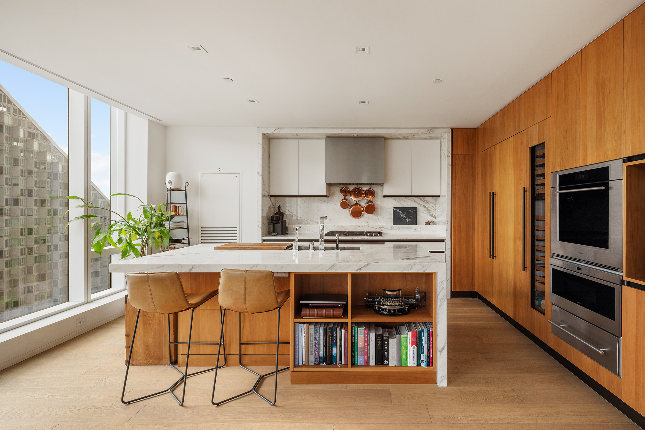 1 West End Avenue, Unit 22E Manhattan, NY 10023 - Photo 3 of 32 a kitchen with a table chairs refrigerator and microwave