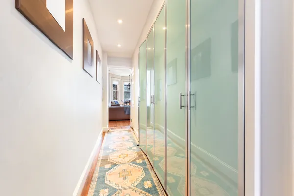 a view of hallway with wooden floor