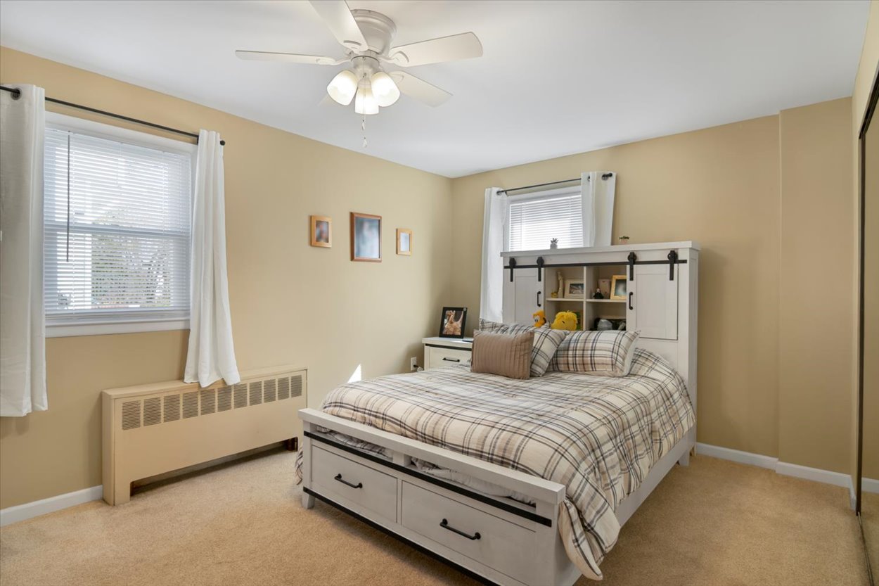 107 Kingston Road Parsippany, NJ 07054 - Photo 18 of 43 a bedroom with a bed and a chandelier