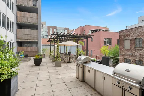 a view of a patio with chairs and potted plants