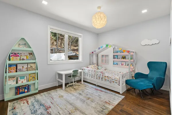 a view of a bedroom with furniture and windows