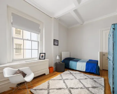 a bedroom with furniture and a large window