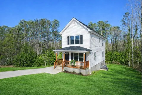 a view of a house with a yard porch and sitting area