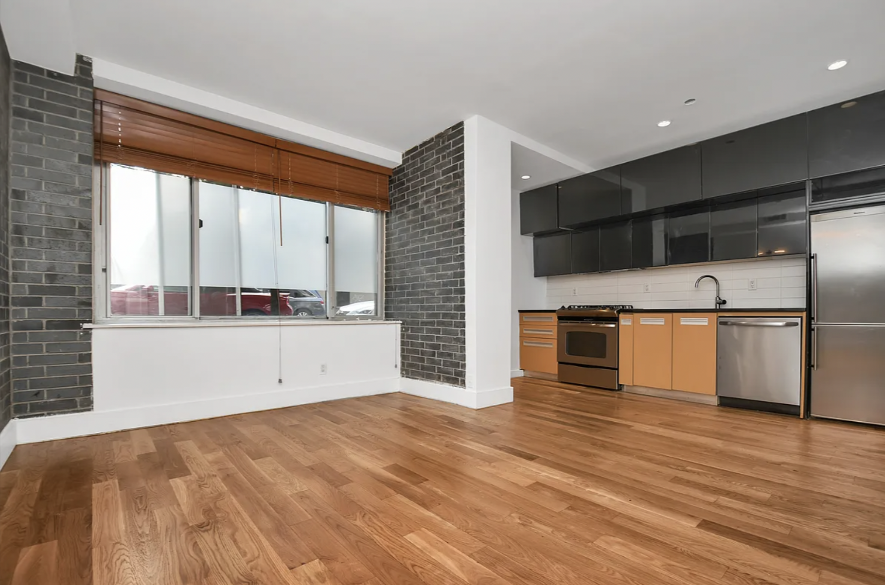 105 Grand Avenue, Unit 1F Brooklyn, NY 11205 - Photo 1 of 7 a view of an empty room with wooden floor and a window