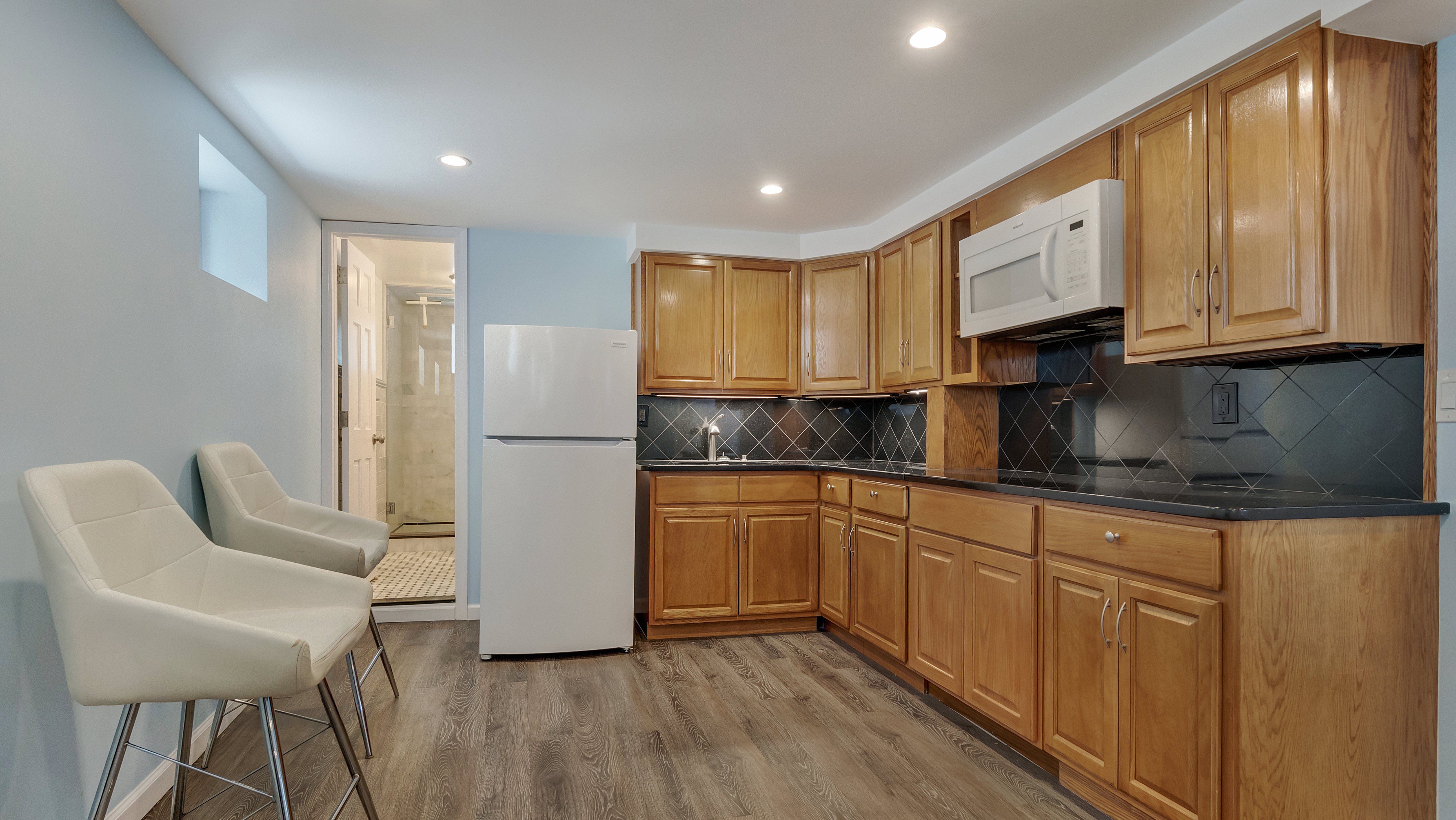 278 Amherst Street Brooklyn, NY 11235 - Photo 10 of 24 a kitchen with granite countertop white cabinets and white appliances