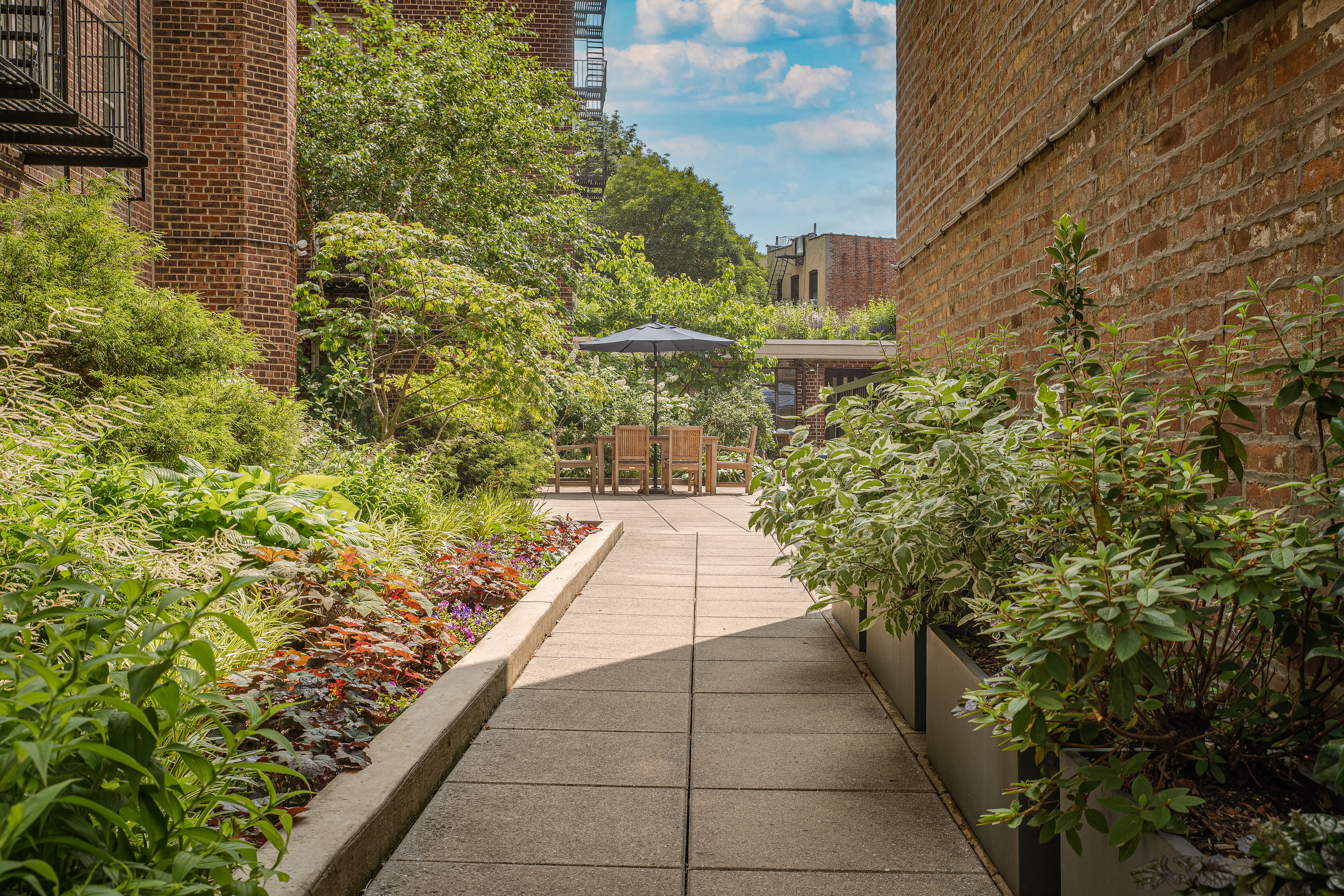 340 Haven Avenue, Unit 2H Manhattan, NY 10033 - Photo 20 of 24 a view of a pathway with flower plants