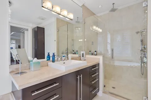 a view of a city with lots of residential buildings ocean and mountain view in back