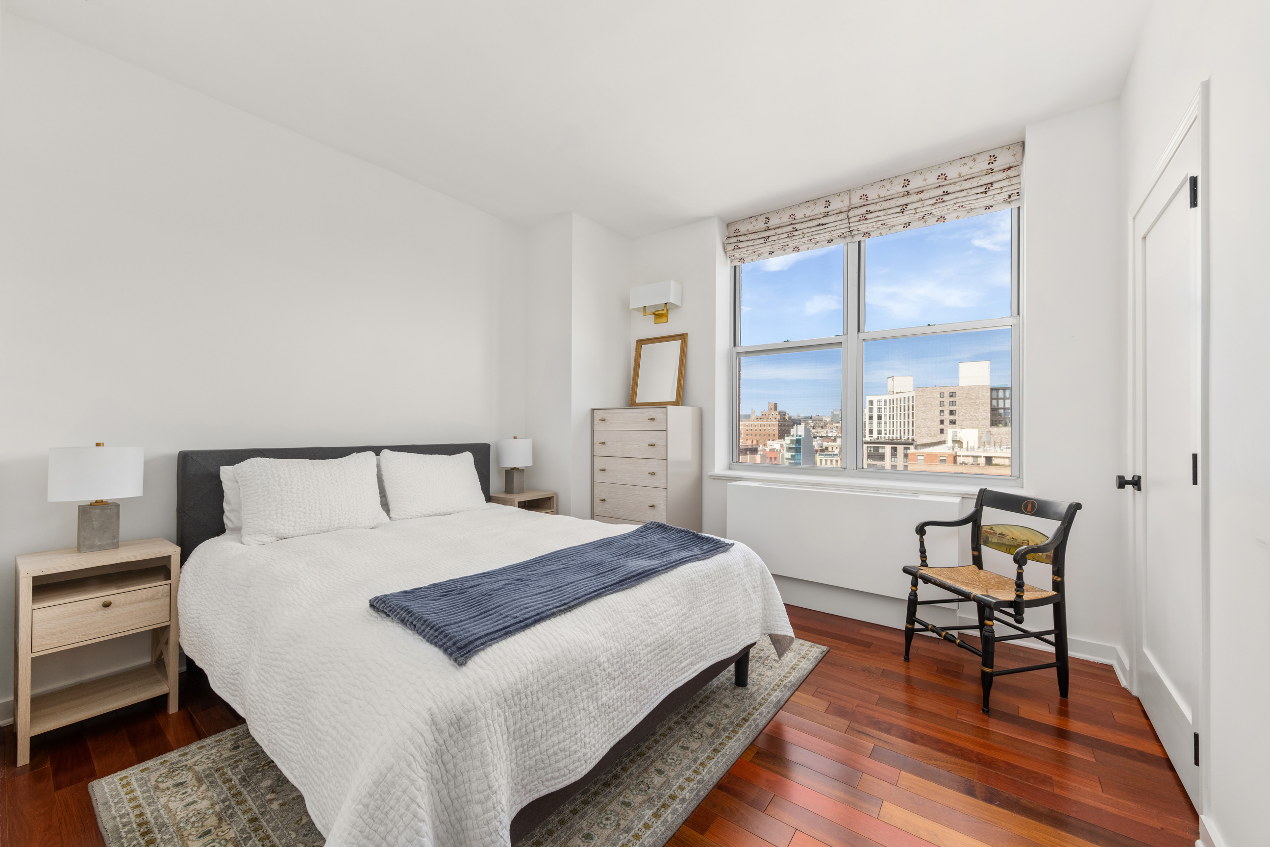 301 West 118th Street, Unit PH1C Manhattan, NY 10026 - Photo 5 of 12 a bedroom with a bed and wooden floor