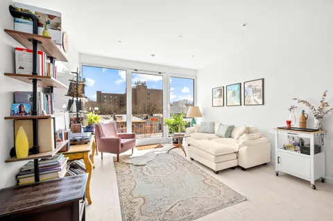 a living room with furniture and a book shelf