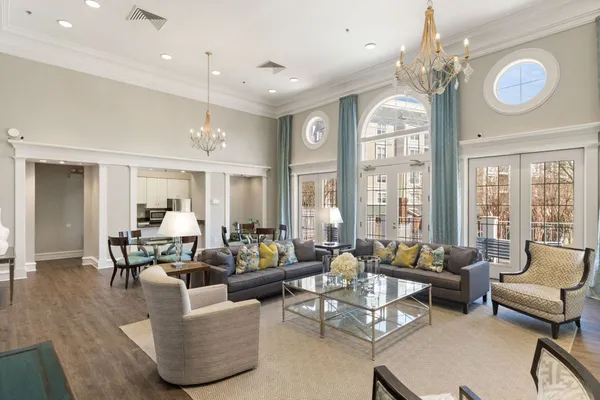 a kitchen with stainless steel appliances granite countertop a refrigerator a sink and white cabinets