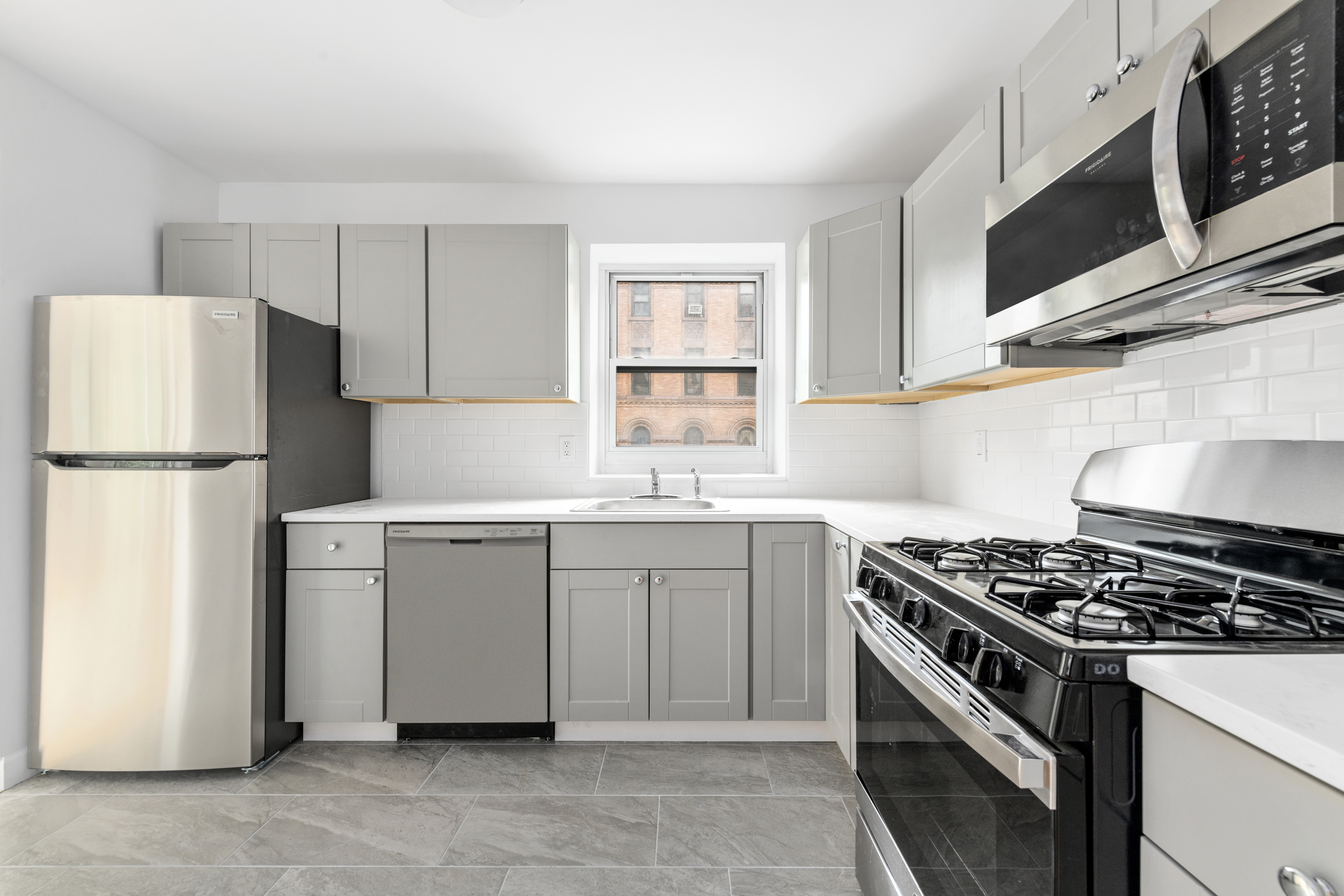 100 West 89th Street, Unit 3E Manhattan, NY 10024 - Photo 3 of 19 a kitchen with white cabinets and white appliances