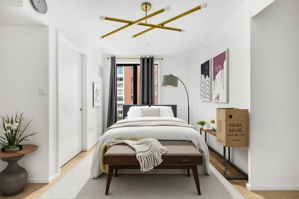 a bedroom with furniture and a potted plant