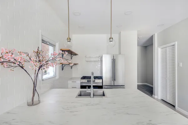 a bathroom with a tub a sink and a shower