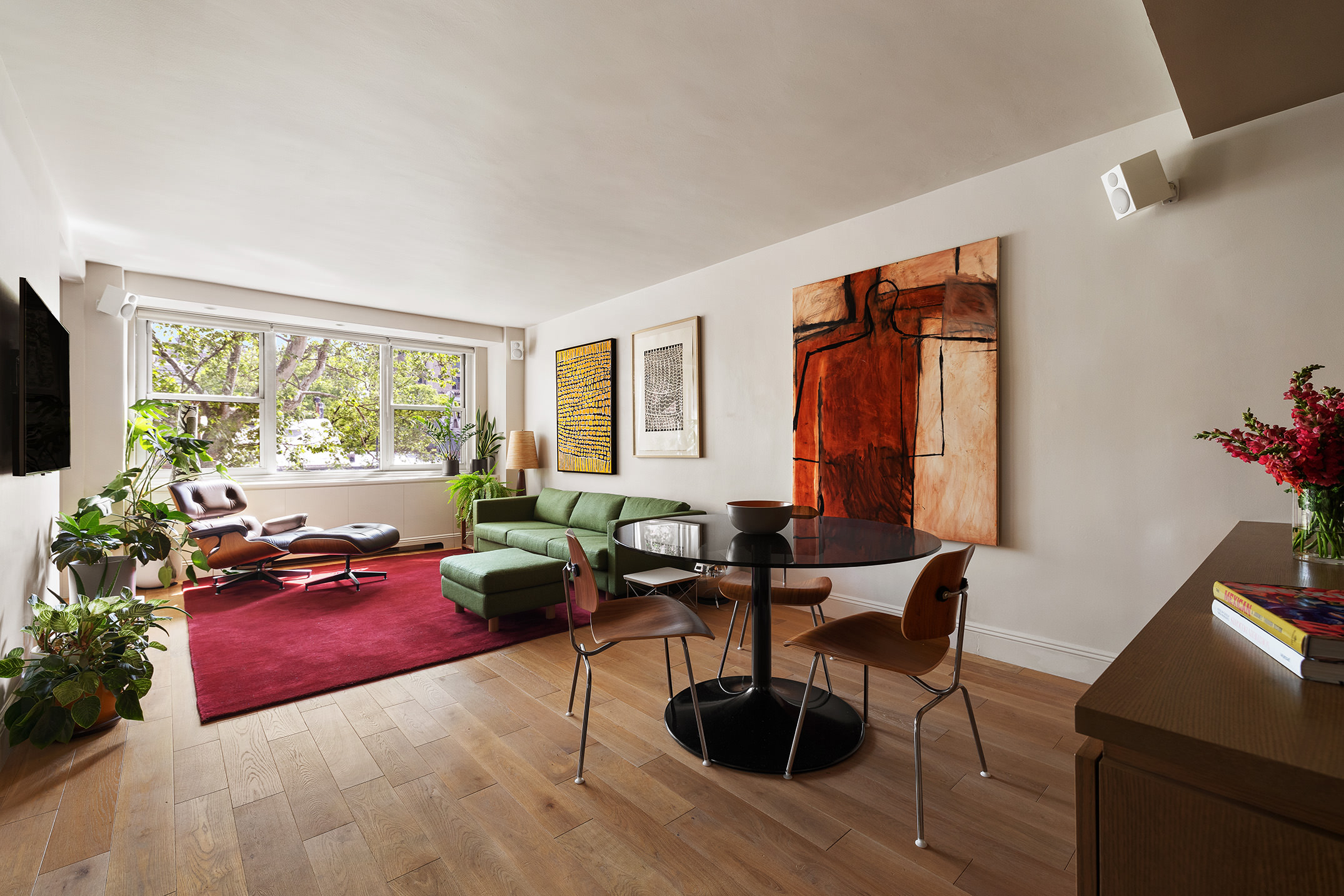 360 West 22nd Street, Unit 5M Manhattan, NY 10011 - Photo 2 of 16 a living room with furniture and a flat screen tv