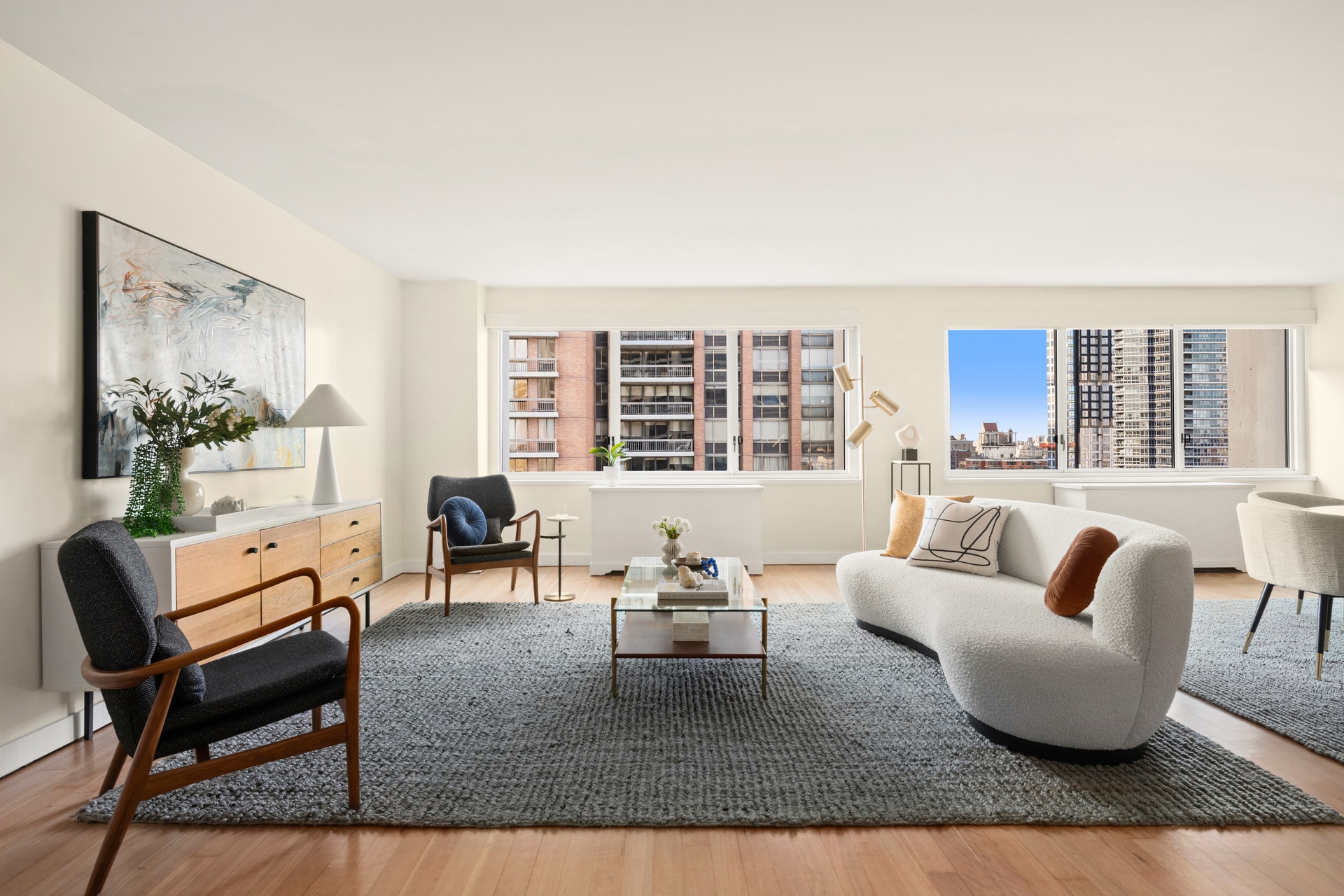 300 East 59th Street, Unit 2103 Manhattan, NY 10022 - Photo 1 of 14 a living room with furniture and a large window