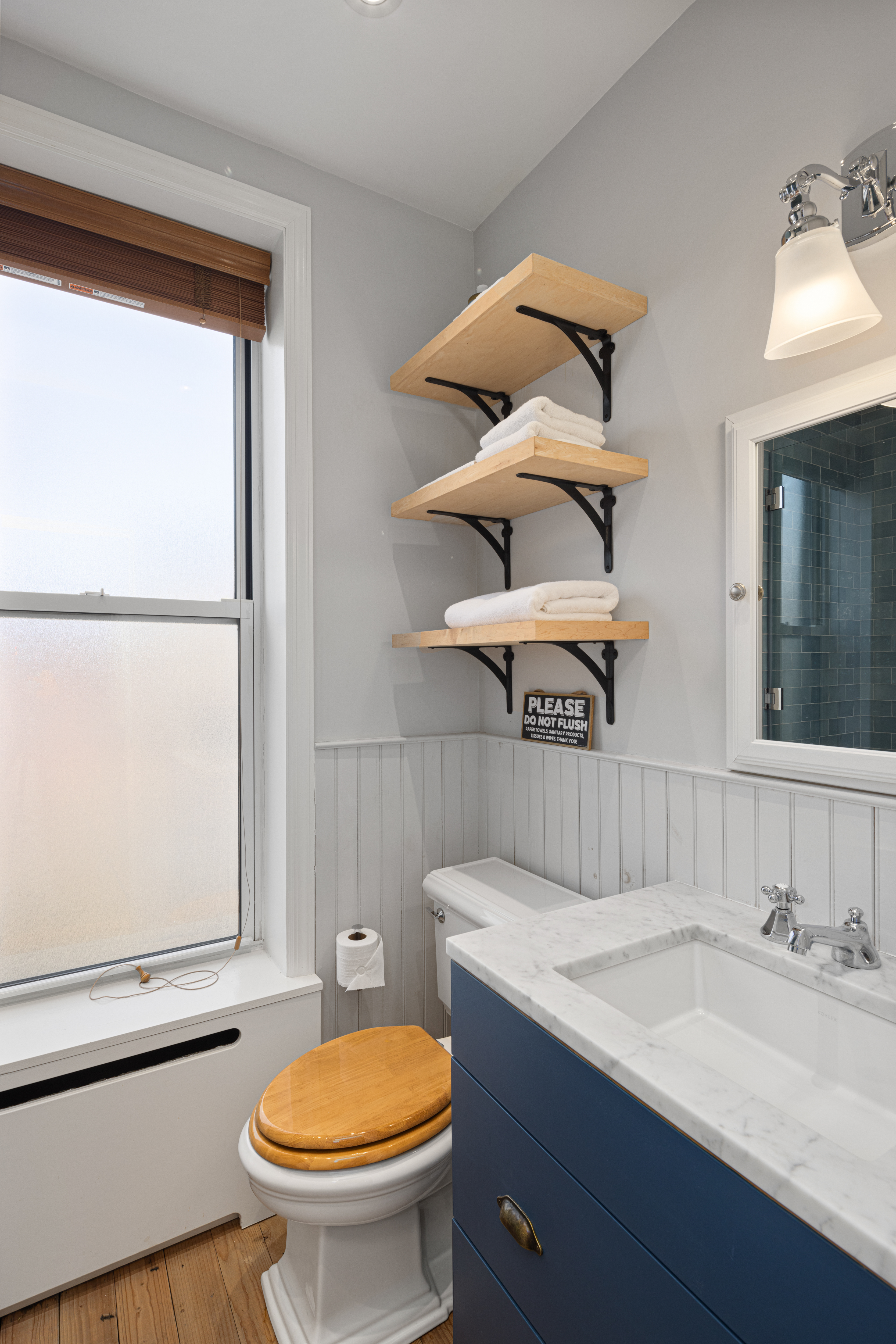 20 Strong Place Brooklyn, NY 11231 - Photo 11 of 21 a bathroom with a sink a toilet and mirror