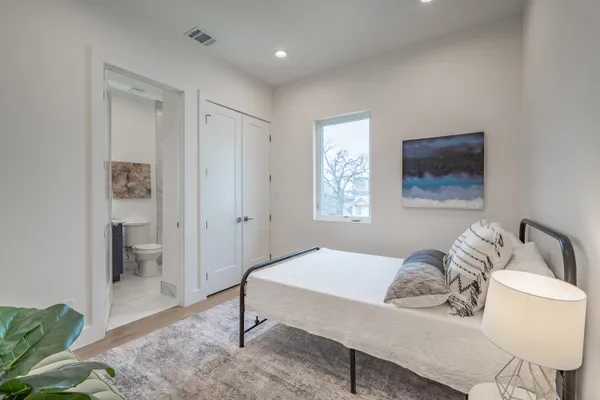 a bedroom with a bed and a table in it