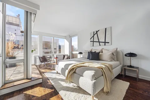 a bed room with a bed and a painting on the wall