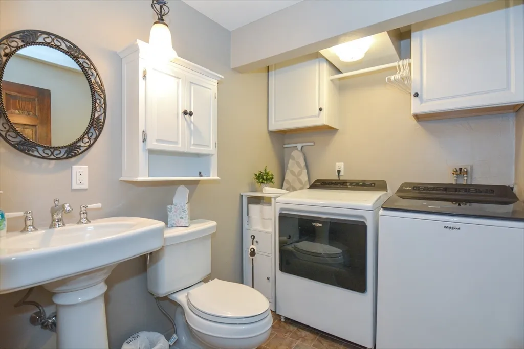 a bathroom with a sink a toilet and a mirror