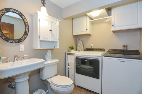 a bathroom with a sink a toilet and a mirror