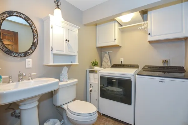 a bathroom with a sink a toilet and a mirror