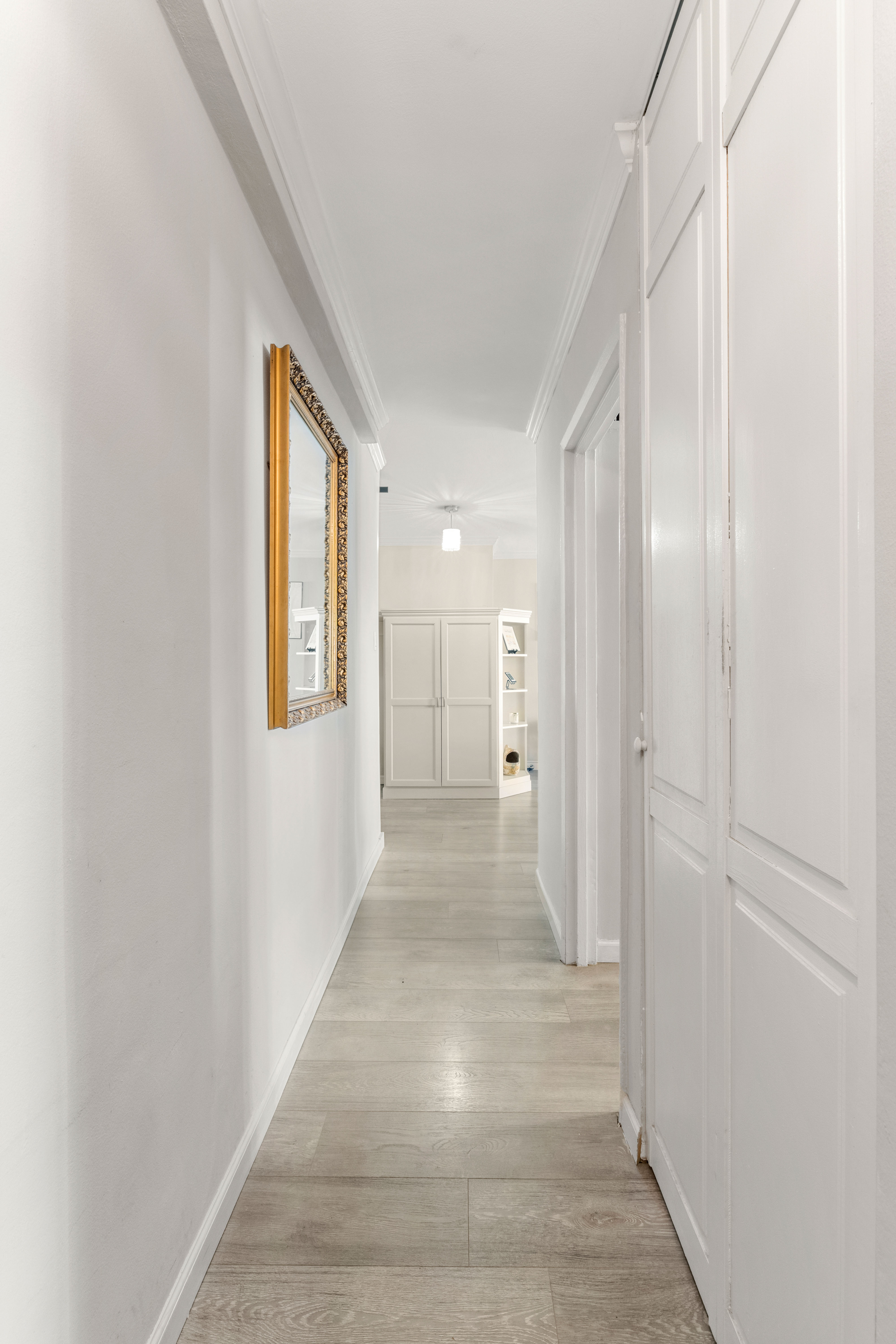 102-30 66th Road, Unit 7E Queens, NY 11375 - Photo 9 of 15 a view of a hallway with wooden floor and a bathroom