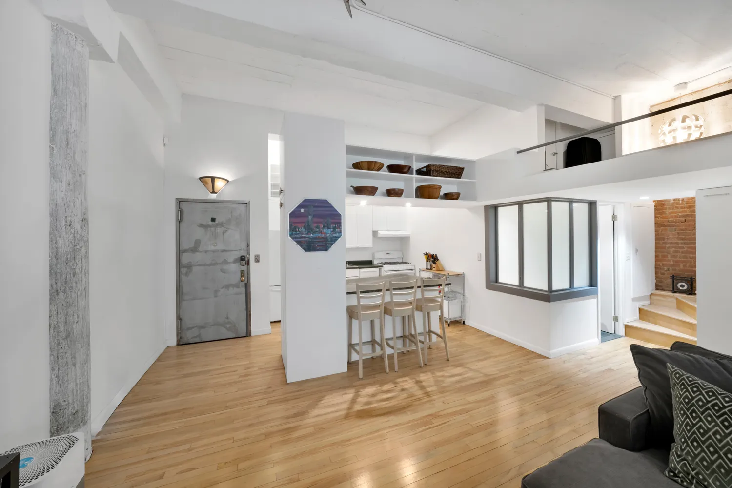 a view of kitchen with furniture and wooden floor